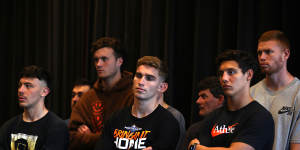 Essendon players look on during Brad Scott’s first press conference as coach on Friday.