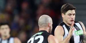 Jack Crisp receives a handball from Steele Sidebottom against the Crows at the Adelaide Oval.