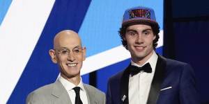 Josh Giddey on stage with NBA commissioner Adam Silver after hearing his name read out for the sixth overall pick in the 2021 draft.