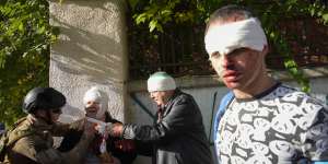 People receive medical treatment at the scene of Russian shelling,in Kyiv.