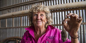 Grain farmer Fiona Adams from Wellington in NSW’s Central West holds a mouse that her dog killed. 