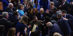 Ukrainian President Volodymyr Zelensky with an American flag given to him by House Speaker Nancy Pelosi.