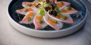 “New style” kingfish sashimi with salmon roe,pickled jalapeno and truffled dashi.