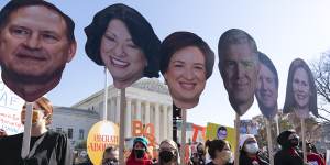 Abortion rights advocates holding cardboard cutouts of the Supreme Court Justices,demonstrate in front of the US Supreme Court,as it hears arguments in the case from Mississippi.