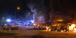 Cars are engulfed by flames after protests broke out at Rosengard in Malmo.