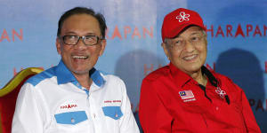 Former Malaysian foes side by side for first time in decades