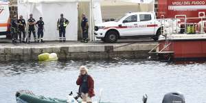 Karsten Borner,the Captain of a Dutch sailing ship,who rescued 15 people from the shipwreck of the Bayesian,stands on a rubber boat at the harbour of Porticello,southern Italy.