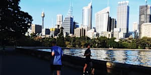 Joggers and walkers along the Farm Cove seawall. 