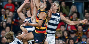 Izak Rankine of the Crows high in the pack over Tom Stewart of the Cats