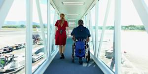 Shane Hryhorec boarding a flight to Japan. Travelling in a wheelchair is totally possible… but the travel industry just needs to get on board.