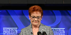 Pauline Hanson and the banner that earlier disrupted her first address to the National Press Club.