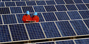 Workers check solar panels at a solar power station on a factory roof in Changxing,eastern China’s Zhejiang province.
