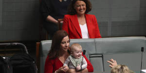 Federal Labor MP Anika Wells arrives with babies Ossian and Dashiell (in pram) during a division.