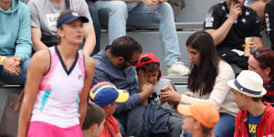 Parents comfort their child at Roland Garros after an outburst from Irina-Camelia Begu.