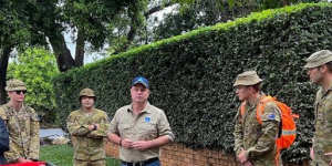 Defence personnel,shown with Brisbane Lord Mayor Adrian Schrinner,helped with the clean-up.