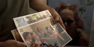 Nahal Neta,son of Adrienne Neta,66,holds a photo of the nurse living in Kibbitz Be’eri missing since a Hamas surprise attack on the Gaza border