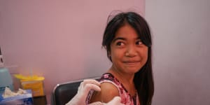 A young girl from Tondo,Manila,is seen in a Likhaan clinic for her free HPV vaccination.