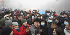 Demonstrators pictured on the streets of Almaty,where government buildings and broadcast offices have been raided and smashed. 