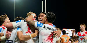 The Dragons celebrate a Tyrell Sloan try.