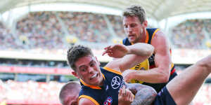 The Crows Patrick Parnell is slung to the ground by Nathan Broad.