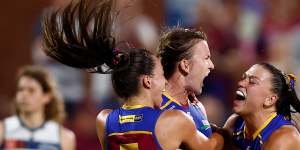 Jade Ellenger,Shannon Campbell and Poppy Boltz of the Lions celebrate during the win over the Cats.