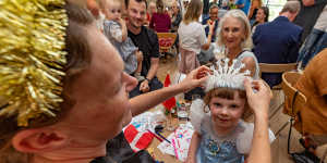 Clara Kynne Schmidt helps three-year-old Ella with a crown at the King’s Ascension Day event in Melbourne on Sunday.