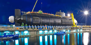 Britain’s third Astute Class nuclear submarine,the Artful,being lowered into the water. 