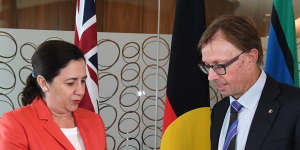 Premier Annastacia Palaszczuk receives the report from Phillip Strachan.