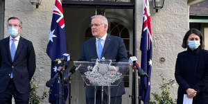Prime Minister Scott Morrison,flanked by NSW Treasurer Dominic Perrottet and Premier Gladys Berejiklian.