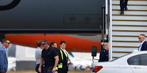Anthony Albanese disembarks from the RAAF plane in the Joy Division t-shirt last Thursday.