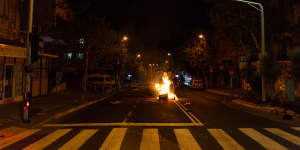 A fire started by rioters in the middle of the street in the Hadar suburb of Haifa,Israel. 