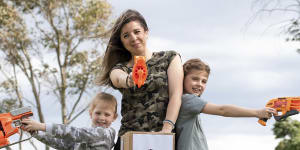 Stavrelle Giourousis and her daughters Georgie,8,and Delphi,5,with their homemade targets and Nerf guns.