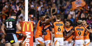 The Tigers celebrate a try on Saturday night.