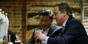 Then-PM David Cameron,right,drinks a pint of beer with Chinese President Xi Jinping,at The Plough pub in Casden,England,in 2015.