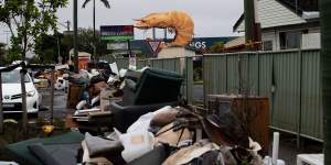 Like middens of loss:Streets in Ballina lined with flood damaged possessions on March 8.