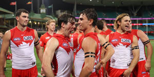 The Swans celebrate their round zero victory against Melbourne in front of a sellout crowd at the SCG.