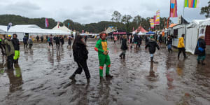 Bring your gumboots:Punters tackle wet conditions at Splendour on Friday.