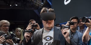 Palmer Luckey demonstrates an Oculus system at an event in 2015.