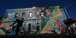 Cycling past a mural in Brougham Street.
