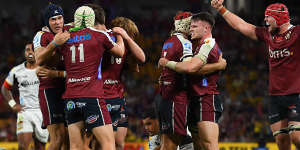 Reds players celebrate victory over the Chiefs at Suncorp Stadium.