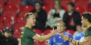 Daly Cherry-Evans and Murray Taulagi celebrate one of 12 Australian tries.