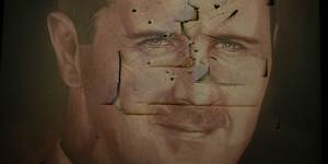 A defaced portrait of Bashar al-Assad inside the presidential palace.