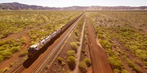 One of Fortescue’s diesel trains plies the Pilbara,taking iron ore to port.