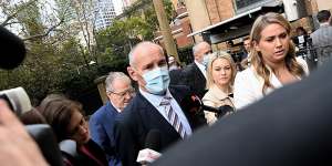 Chris Dawson (centre) arrives at the NSW Supreme Court for the announcement of his verdict on August 30.