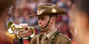 The Last Post is played on Anzac Day before the Essendon vs Collingwood clash at the MCG.