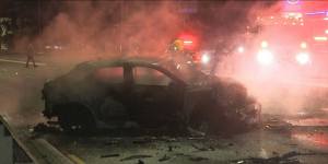 Manhunt under way after fiery crash leaves man critical