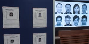 Photos of eight activists who have been issued arrest warrants over national security are displayed during a press conference in Hong Kong,