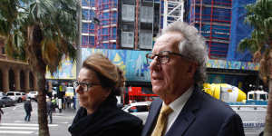 Actor Geoffrey Rush arrives at court on Tuesday with his wife Jane Menelaus.