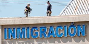 FBI agents investigate the crime scene near the Immigration and Customs Enforcement office in Dallas,Texas.