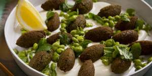Falafel with broad beans and spice on tahini sauce.